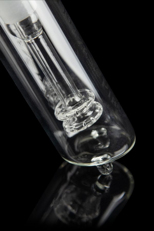 Close-up of a clear glass bong with intricate percolators against a black background.