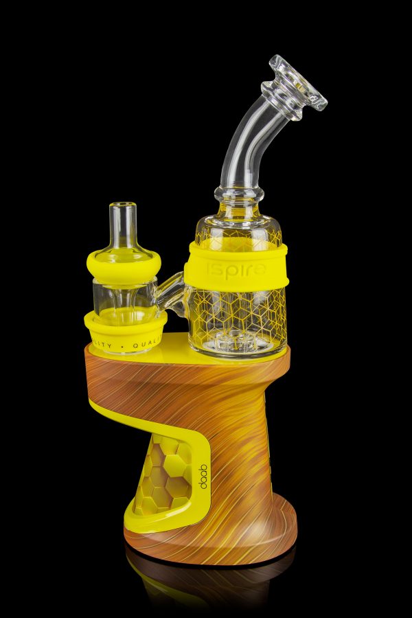 Yellow and wood-grain DabRig cannabis vaporizer with glass water pipe attachment.