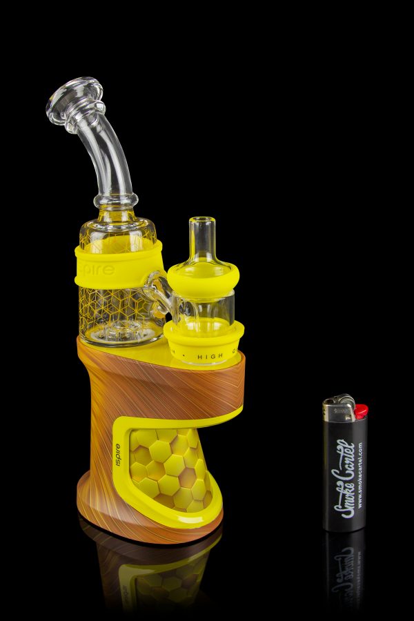 Brown electronic dab rig with glass water pipe attachment and lighter, reflecting on a glossy surface.