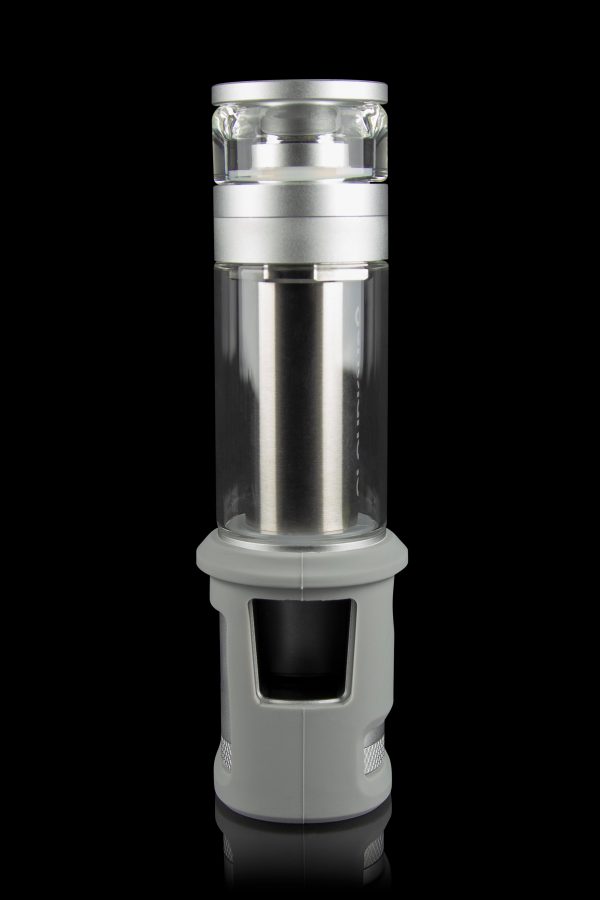 Silver cannabis water pipe with a cylindrical glass chamber and textured base, isolated on a black background.