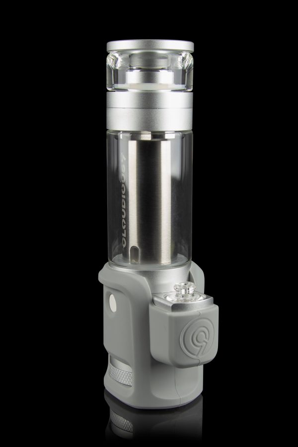 Silver and gray cannabis oil vaporizer with glass chamber, displayed against a black background.
