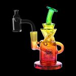 Colorful glass dab rig with accompanying nail, isolated on black.