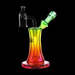 Colorful glass dab rig with quartz banger and mouthpiece against a black background.
