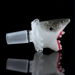 The Empire Glassworks "Jawsome" Bowl Piece is pictured from a low angle against a black background, showcasing its shark-themed design.