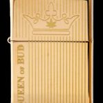 Gold Zippo-style lighter engraved with a cannabis leaf crown and the text “Queen of Bud.”