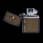 Two Zippo-style lighters with cannabis leaf designs and “Queen of Bud” text against a black background.