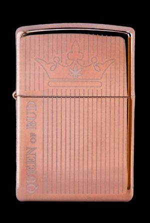 Copper-colored lighter engraved with vertical lines and the phrase “Queen of Bud” with a crown illustration.