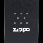 Black Zippo lighter box with a cannabis leaf pattern and logo.