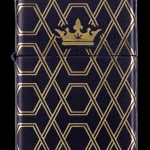 Black Zippo-style lighter with a gold geometric pattern and a cannabis leaf within a crown at the top.