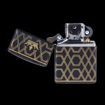 Art Deco-style black and gold lighter, open and displaying interior.