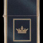 Gold Zippo-style lighter with a gold crown emblem on a black textured background.