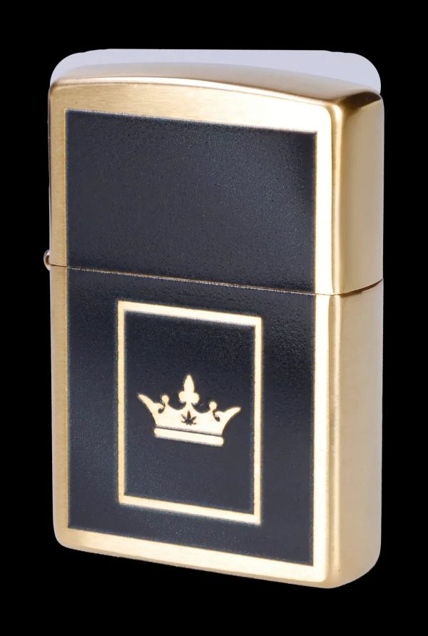 Gold lighter with a cannabis leaf crown emblem on a black inset.