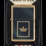 Zippo lighter with a gold crown emblem, packaged in a black insert.