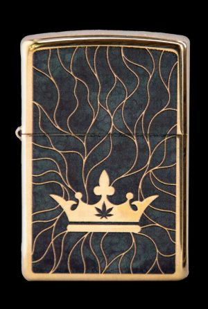 Gold Zippo lighter with a black background featuring a golden crown and cannabis leaf design.
