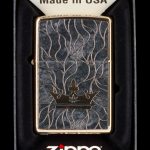 Zippo lighter with engraved cannabis leaf and vine design in a black display box.