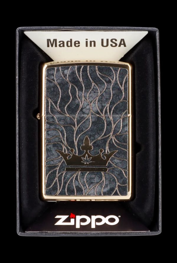 Zippo lighter with engraved cannabis leaf and vine design in a black display box.