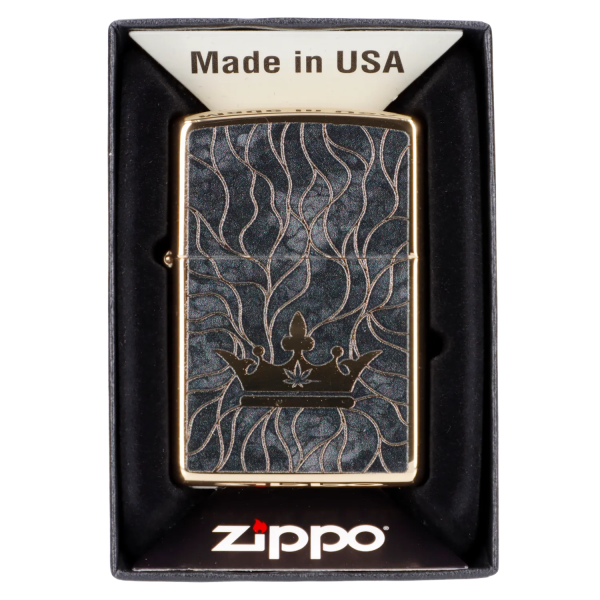 Zippo lighter with a black and gold cannabis leaf design in its packaging.