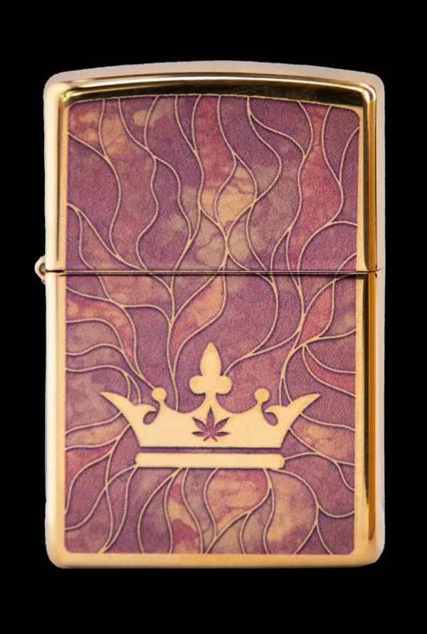 Gold lighter engraved with a crown and cannabis leaf.