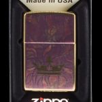 Zippo lighter with a burgundy and gold cannabis leaf design, displayed in a black box.