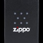 Black Zippo lighter box with cannabis leaf-shaped dots and logo.