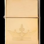 Gold Zippo lighter engraved with a spade suit playing card.
