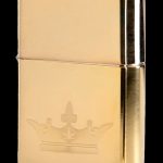 Gold Zippo lighter engraved with a cannabis leaf design.