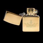Gold lighter with a crown emblem, open and displaying interior components.