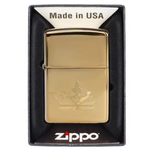 Gold Zippo lighter engraved with a cannabis leaf design in its packaging.