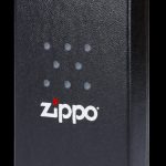 Black Zippo case with cannabis leaf pattern.