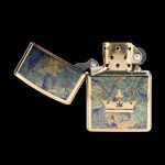 Gold lighter with a cannabis leaf crown design, open and displayed on a black background.