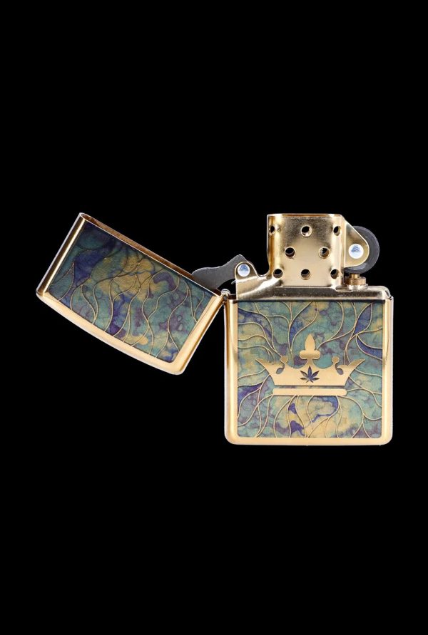 Gold lighter with a cannabis leaf crown design, open and displayed on a black background.