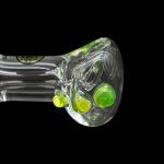 Green glass cannabis spoon pipe with colorful bubbles.
