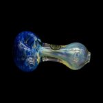Glass pipe with blue and iridescent green swirls, isolated on a black background.
