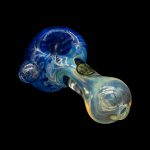 Hand-blown glass cannabis pipe with blue and yellow swirls against a black background.