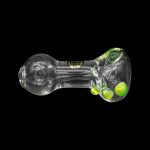 Glass pipe with green and iridescent bubbles, isolated on a black background.