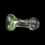 Glass pipe with green accents against a black background.
