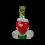 Red mushroom-shaped glass water pipe on a white base, isolated on black.