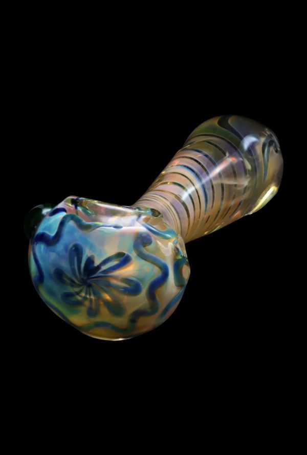 Iridescent glass pipe with floral detailing against a black background.