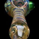 Iridescent glass pipe against a black background.