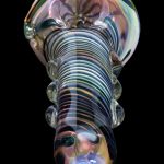 Colorful glass pipe with swirling patterns, isolated on a black background.