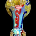 Hand-blown glass pipe with swirling red, blue, and gold patterns.