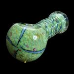 Green and teal speckled glass pipe against a black background.