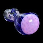 Purple glass cannabis pipe against a black background.