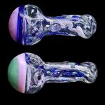 Two glass pipes with intricate blue and purple swirls, set against a black background.
