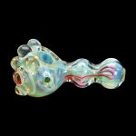 Iridescent glass pipe with swirling red and blue accents, isolated on a black background.