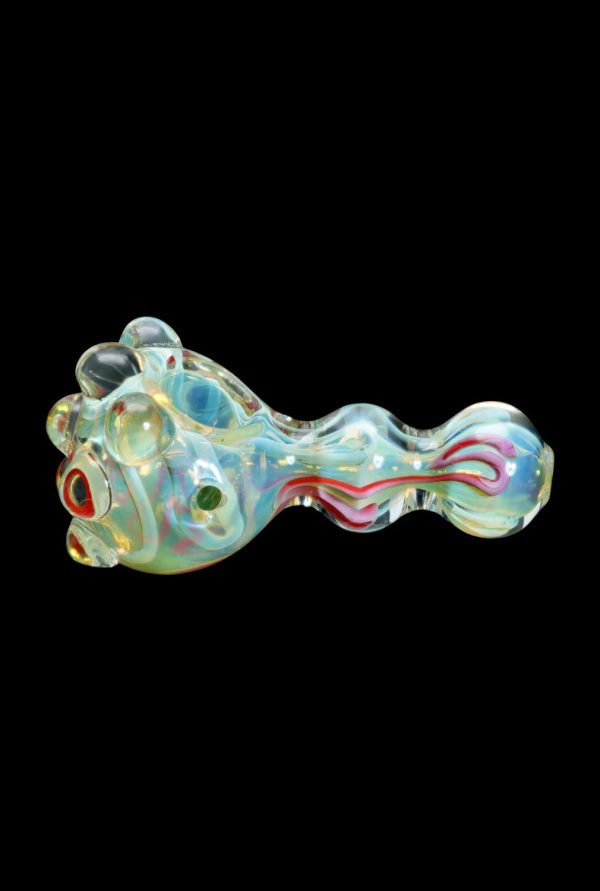 Iridescent glass pipe with swirling red and blue accents, isolated on a black background.