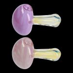 Two iridescent pink and lavender glass smoking pipes against a black background.