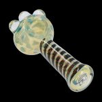 A close-up, angled view of the Dicro Spoon Pipe - 4.5 in., showcasing its smooth glass form and unique dichroic finish.