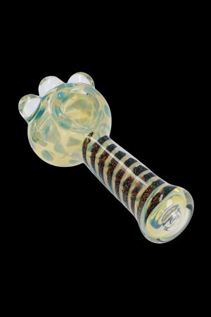 A close-up, angled view of the Dicro Spoon Pipe - 4.5 in., showcasing its smooth glass form and unique dichroic finish.