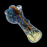 Colorful glass smoking pipe with swirling blue, yellow, and red patterns against a black background.